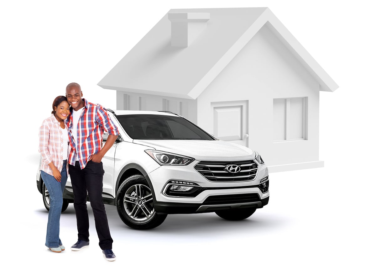 Happy couple standing with their new car outside their home.